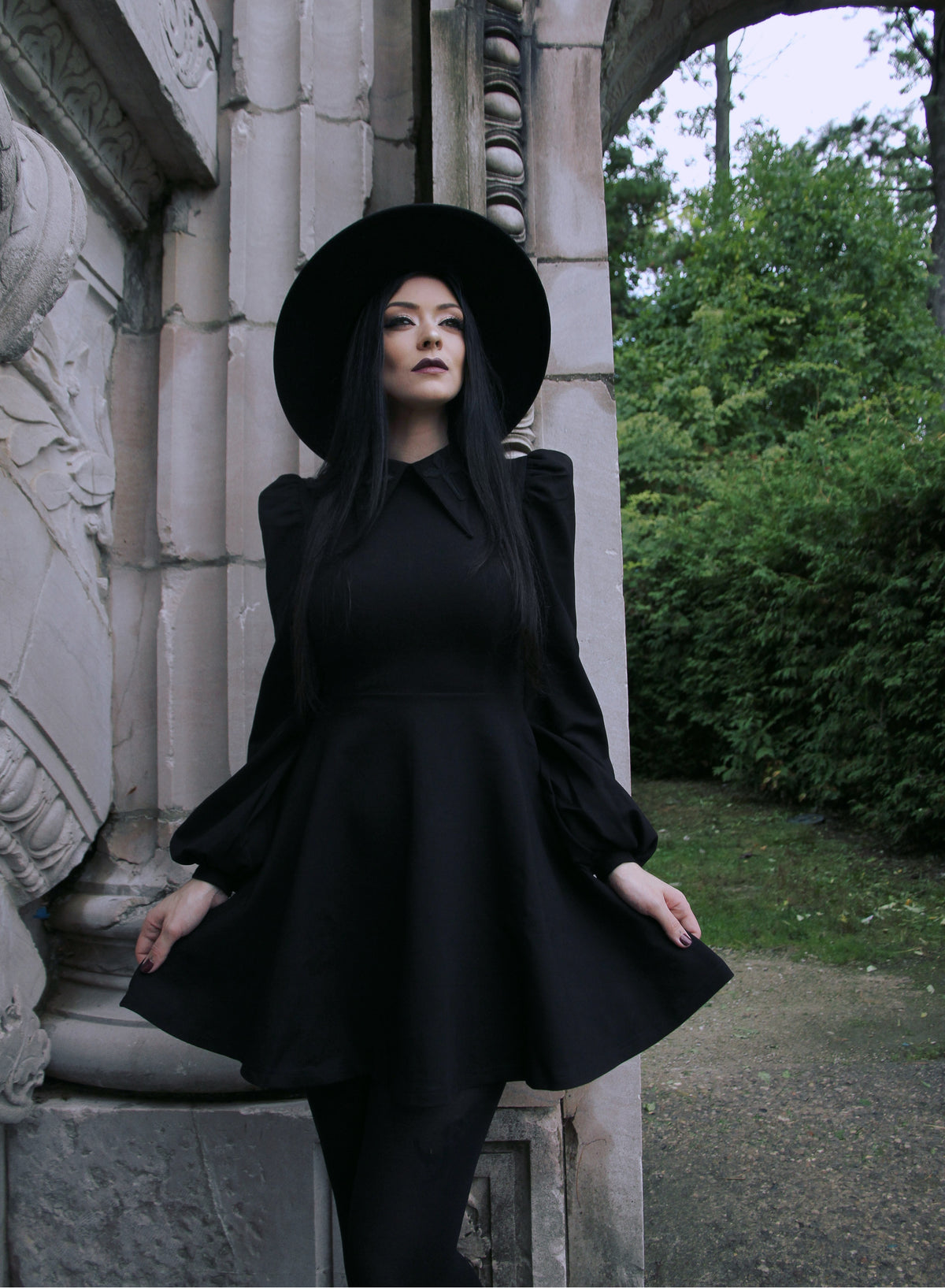 Delight in every detail with this black Baptism Dress, complete with a large pointed collar subtly embroidered with a cross for a unique and charming touch. Available with a classic black or lively red collar, the dress combines puffed shoulder design with flowing bishop sleeves for a stylish and graceful look. Made from high-stretch thick ponte fabric, it provides comfort, warmth, and durability, perfect for cooler months and cherished occasions.