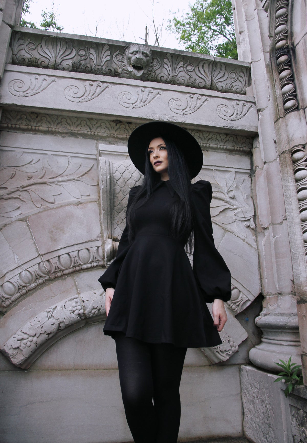 Capture the magic of special occasions with this black Baptism Dress featuring a statement pointed collar with subtle cross embroidery. Available with a black collar for timeless elegance or a red collar for a hint of playfulness, the dress’s puffed shoulders and flowing bishop sleeves add an extra touch of charm. Crafted from soft, high-stretch ponte fabric, it offers warmth, comfort, and freedom of movement, ideal for cooler seasons.