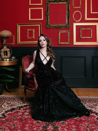 Celestial Dress in embroidered chiffon with a subtle constellation pattern, available in black and white. This elegant maxi dress features sparkly fabric, a low-cut neckline, and chic cross-strap detailing, perfect for special events, evening parties, or nights out, offering timeless sophistication and modern celestial style.