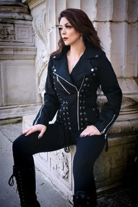 Vixxsin Chantira Jacket in black, crafted from durable 100% cotton with soft polyester lining, featuring a fitted moto-style design with heavy grommet lace-up detailing on the front, back, and sides, asymmetrical zip closure, zipped cuffs, and adjustable ties for a bold, structured, and edgy look perfect for alternative fashion enthusiasts.