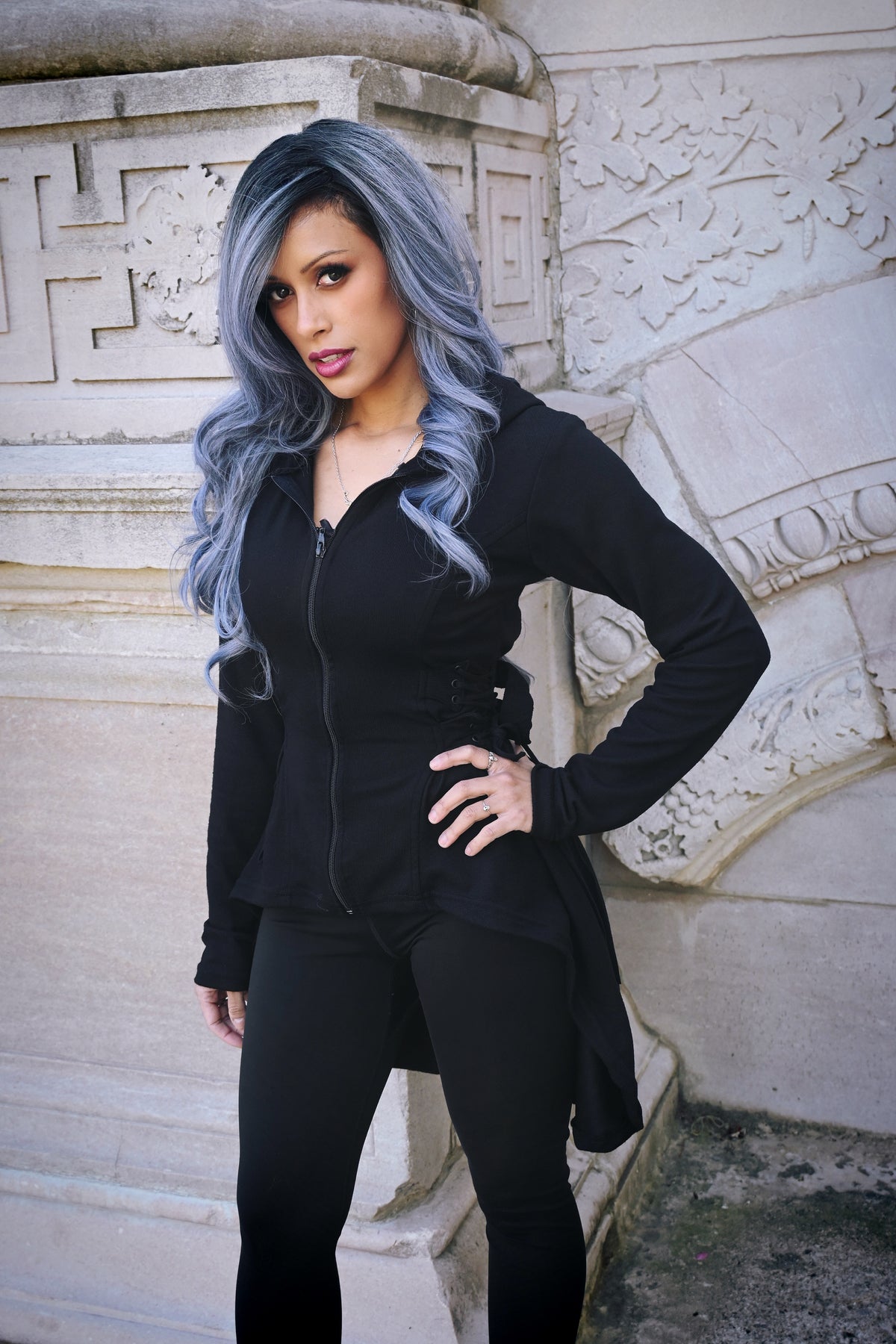 Lightweight black Heartless hoodie made entirely of soft polyester, featuring a fitted design, oversized hood, thumbholes, high-low hem, and corset-style lacing with adjustable back ties, ideal for edgy layering and all-day comfort throughout the year.