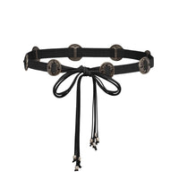 Silver concho belt with tie closure and spaced medallions, designed to cinch the waist for a flattering silhouette. Ideal for alternative fashion, gothic ensembles, or edgy statement outfits.