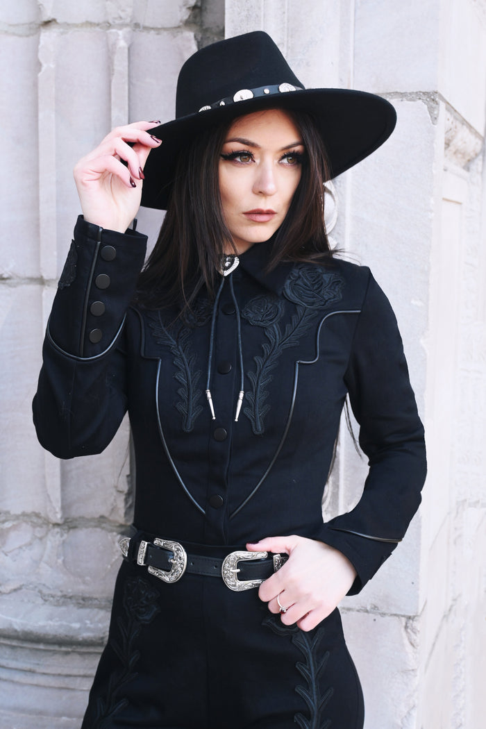 This edgy black Dallas Top features a decorative matte snap-front closure with hidden interior snaps for a secure and comfortable fit, making it a perfect blend of gothic aesthetic and functional design for everyday wear or statement outfits.