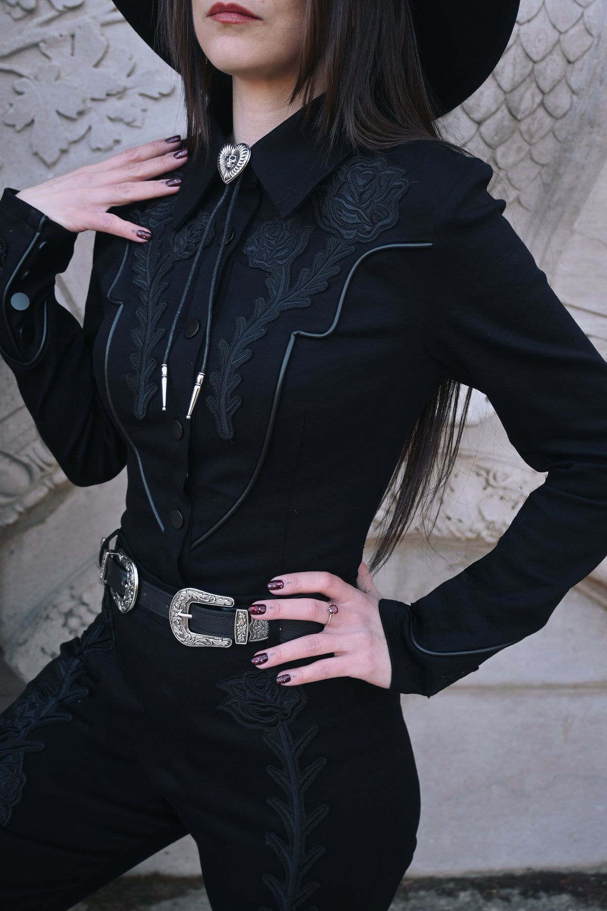 Made from durable, high-stretch denim, the Dallas Top maintains its shape and intricate black rose and thorn embroidery over time, offering both comfort and a statement gothic aesthetic that stands out in casual or alternative fashion ensembles.