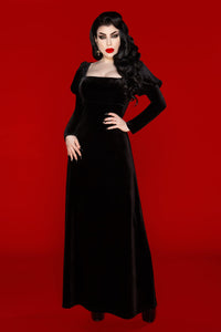 The Daphne Dress is a luxurious black velvet gown inspired by Regency-era elegance and Audrey Hepburn’s timeless look in War and Peace. Crafted from soft, stretchy polyester velvet, this dress embodies dark sophistication with its empire waist, puffed Victorian long sleeves, and flattering scoop neckline that highlights the décolletage. Perfect for gothic fashion lovers seeking a romantic yet refined alternative look.