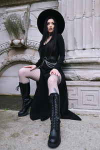 The Kassandra Maxi Dress combines comfort and style with its ultra-stretchy poly blend material and form-fitting silhouette. Its low-cut neckline draws attention to the décolletage, while twin thigh slits create a graceful, confident edge perfect for any season.