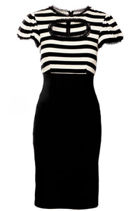 This Molly Keyhole Dress from Shop Katakomb channels classic Jessica Louise styling with a modern twist. The body-hugging stretch bengaline material enhances curves while maintaining comfort, and the high waistline gives a defined, elegant shape. The puff sleeves and ruffled skirt hem bring romantic, vintage appeal, contrasted by a daring keyhole neckline that adds a bold, confident touch. Finished with the designer’s signature Heart Bow, it’s the perfect blend of playful and polished.