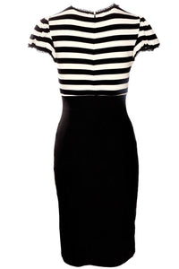 The Jessica Louise Molly Keyhole Dress is a chic, curve-enhancing dress that merges playful femininity with timeless retro influences. Crafted from high-quality stretch bengaline, the design showcases a flattering fitted silhouette, elevated waistline, and graceful ruffle details. Its puff sleeves and keyhole bust cutout offer a balance of modesty and allure, while the signature Heart Bow embellishment adds a hint of whimsy. Ideal for alternative fashion enthusiasts.