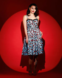 Jessica Louise Love Bites Swing Dress in custom Leopard Print featuring a sweetheart bustline with playful ruffled details and a ribbon bow accent, designed with enlarged cup sizing for confidence and comfort, side seam pockets for practicality, ruched back for effortless wear, and adjustable straps for a personalized, flattering fit, crafted from high-stretch fabric for comfort while making a bold fashion statement.