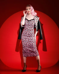 A bold and glamorous Love Bites Pencil Dress in custom leopard print by Jessica Louise, featuring a flattering sweetheart bustline with ruffled trim and a delicate ribbon bow accent. This high-stretch, body-hugging pencil dress offers adjustable straps and a ruched back for easy wear, blending fierce leopard style with feminine elegance — perfect for confident women who love retro-inspired, bad-girl fashion.