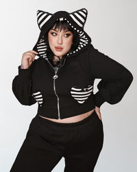 Meow Kitty Sweater in black with dramatic puff sleeves, whimsical striped cat ears, heart-shaped pockets, and a bold back 'Meow' print, designed by Jessica Louise Clothing & Katakomb for nostalgic 2000s scene fashion enthusiasts.