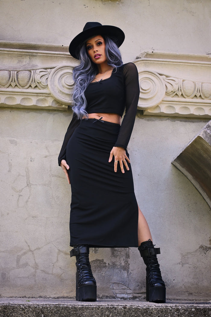 A sultry and stylish women’s two-piece mesh outfit featuring a fitted crop top with a square neckline and long sheer sleeves, paired with a high-waisted pencil skirt with a side slit, crafted from soft, stretchy polyester mesh for a comfortable, body-hugging fit, complete with delicate bow accents, perfect for night outs, parties, and elegant casual wear.