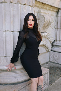 Statement black Mistress Dress combining a curve-enhancing bengaline body, delicate sheer mesh neckline, and exaggerated bishop sleeves, creating a powerful and stylish piece for gothic fashion enthusiasts, formal parties, or anyone looking for a sophisticated and dramatic outfit.