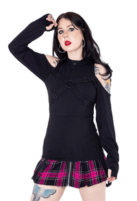 Model posing against white background while wearing the Anidori top and pink plaid skirt.