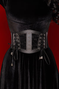 Black lace corset belt with vegan leather panels and stretch back, designed to cinch the waist and elevate dresses, blazers, or oversized shirts with a bold, feminine silhouette.