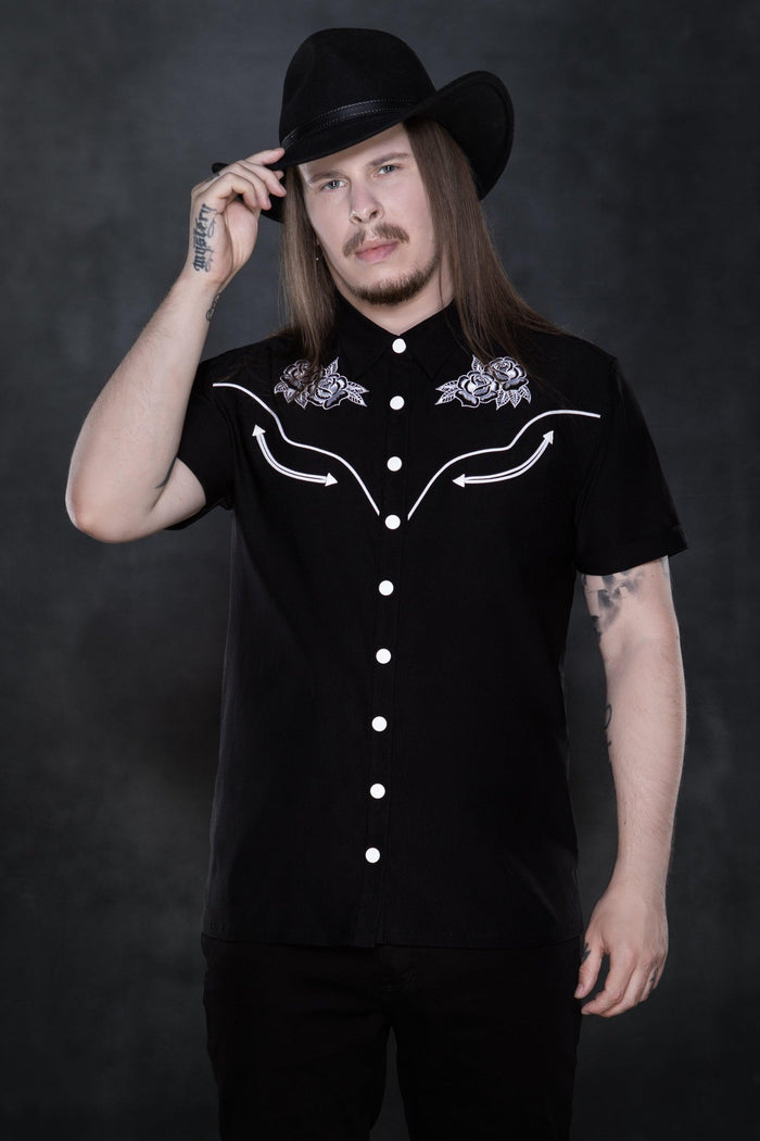 Black Johnny Western Shirt crafted from soft, durable Bengaline fabric, designed with a flattering, tailored cut and a crisp silhouette. Features unique western-inspired details, pristine white snap buttons, minimalist piping along the edges, and an elegant rose pattern, making it a timeless, versatile wardrobe staple perfect for casual and smart-casual outfits.