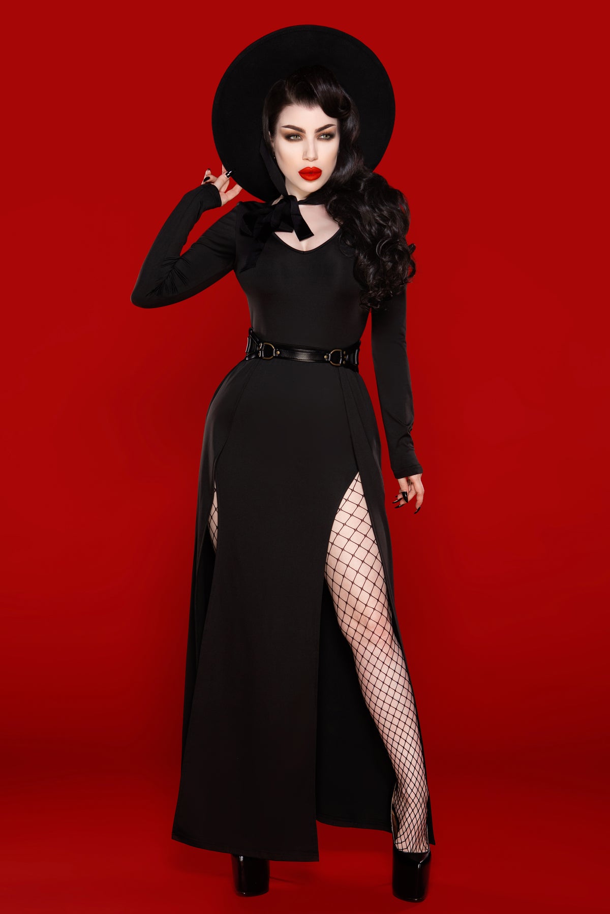 A luxurious Kassandra Maxi Dress made from a high-quality, ultra-stretchy poly blend that contours to the body, offering both comfort and elegance. This timeless piece features a deep low-cut neckline that enhances the décolletage and two thigh-high slits that strike the perfect balance between allure and sophistication.