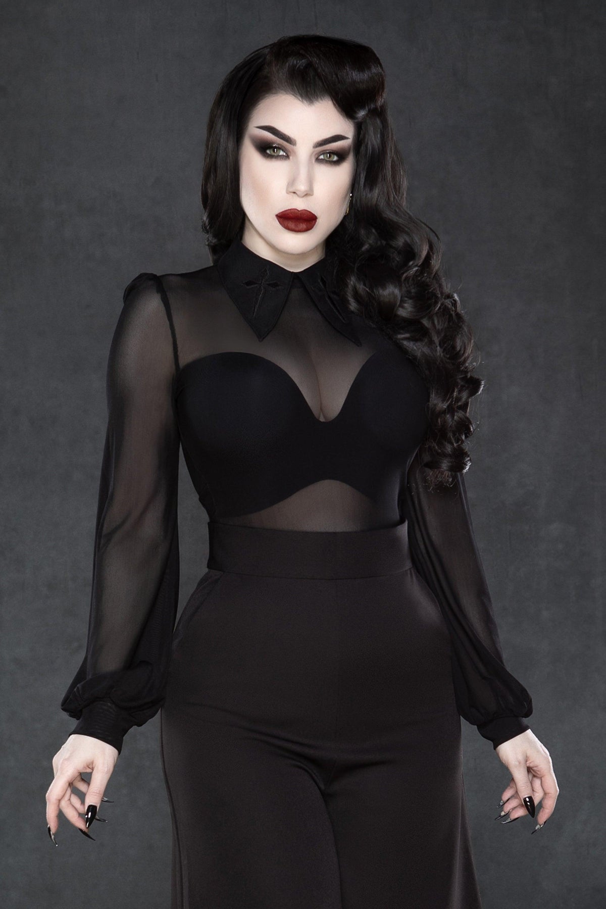 Sheer mesh long-sleeve top designed for fashion-forward individuals, featuring intricate embroidered crosses on a statement elongated collar, stretchy soft fabric for movement, a back keyhole opening, and versatile colors, ideal for clubwear, festival outfits, and gothic street style.