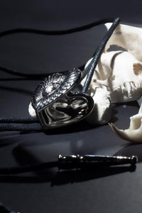 Elegant custom bolo tie featuring dual photo lockets for cherished memories, precision logo etching, and luxurious craftsmanship using fine materials, designed to capture the perfect blend of classic Western heritage and modern individuality.