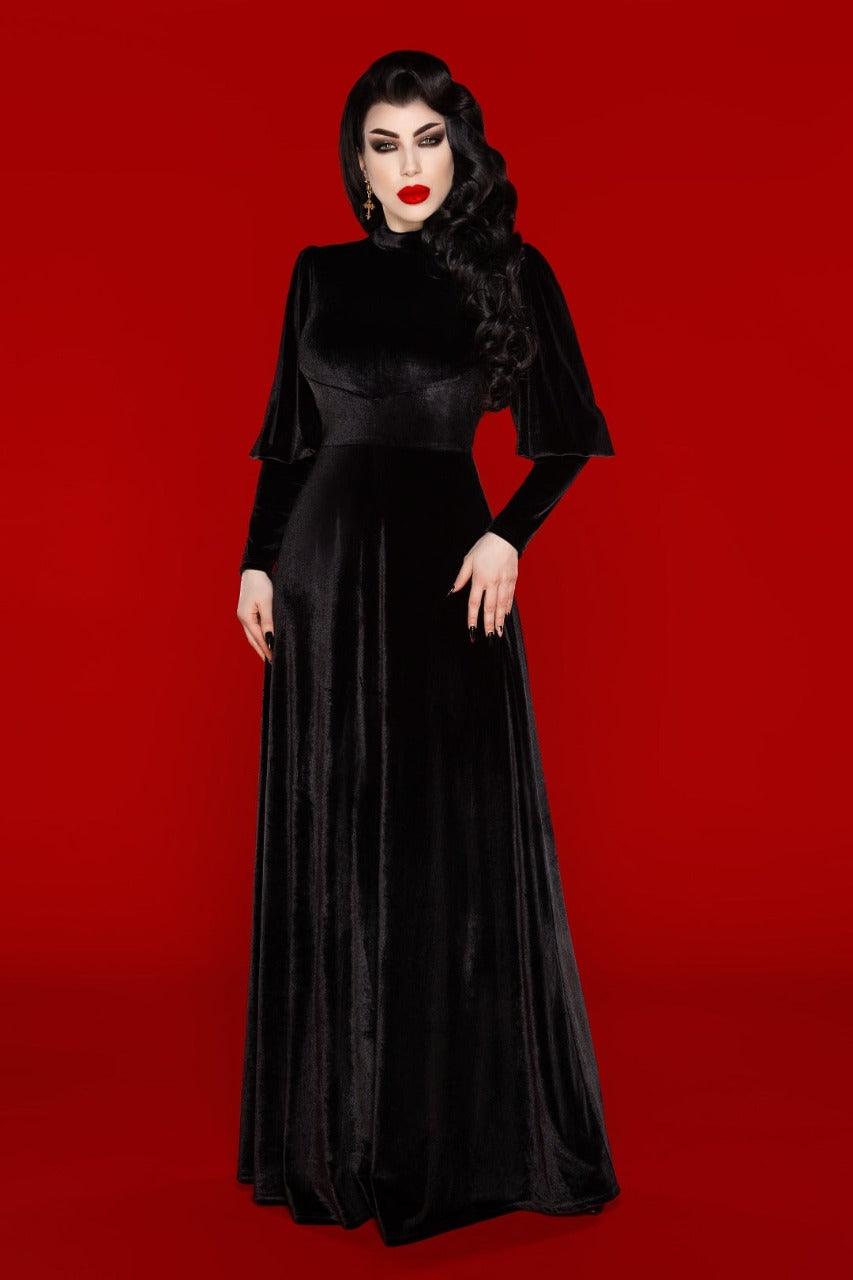 Elegant Arcadia Dress in black high-stretch polyester, inspired by 14th-century medieval fashion and designed for alternative style enthusiasts. This maxi dress features a sophisticated mock turtleneck that adds a regal touch, while the long bishop sleeves create a flowing, ethereal silhouette. The high-stretch fabric ensures a comfortable fit that drapes gracefully over the body, highlighting individual style. Perfect for gothic events, Renaissance fairs, or adding dramatic, otherworldly elegance.