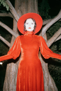 The Arcadia Dress in deep red captures the spirit of medieval elegance blended with modern gothic style. Made from luxuriously soft, high-stretch polyester, this enchanting maxi dress features long bishop sleeves, a regal mock turtleneck, and a flowing silhouette that drapes gracefully to the floor. Perfect for Renaissance fairs, gothic fashion enthusiasts, or anyone drawn to ethereal, vintage-inspired alternative clothing.