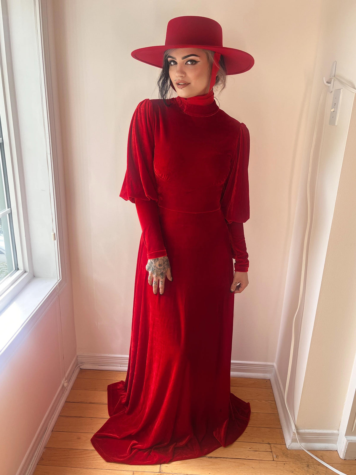 Step into timeless elegance with the Arcadia Dress in crimson red, designed to merge 14th-century inspiration with alternative gothic charm. The soft, stretchy polyester fabric allows a comfortable, flattering fit, while its majestic maxi length, bishop sleeves, and mock turtleneck evoke enchantment and power.