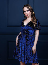 Elegant blue velvet Astral Dress adorned with shimmering gold stars, featuring trendy puff sleeves and a flared skater skirt. Ideal for weddings, evening events, and festive parties, this chic cosmic-themed dress offers a fashionable silhouette and effortless celestial style.