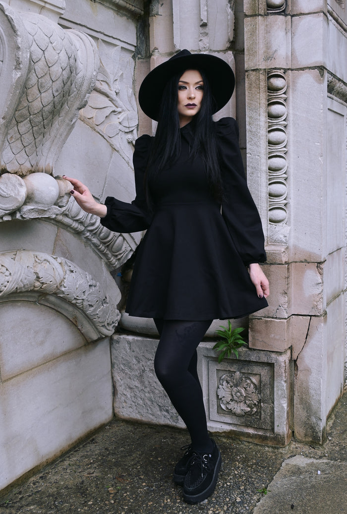 Beautiful black Baptism Dress, featuring a large pointed collar with delicate cross embroidery for a subtle yet charming detail. Choose between a classic black collar for a timeless look or a vibrant red collar for a pop of color. The puffed shoulders and elegant bishop sleeves add a graceful, dramatic touch, while the soft and stretchy thick ponte fabric keeps you comfortable and cozy during cooler months.