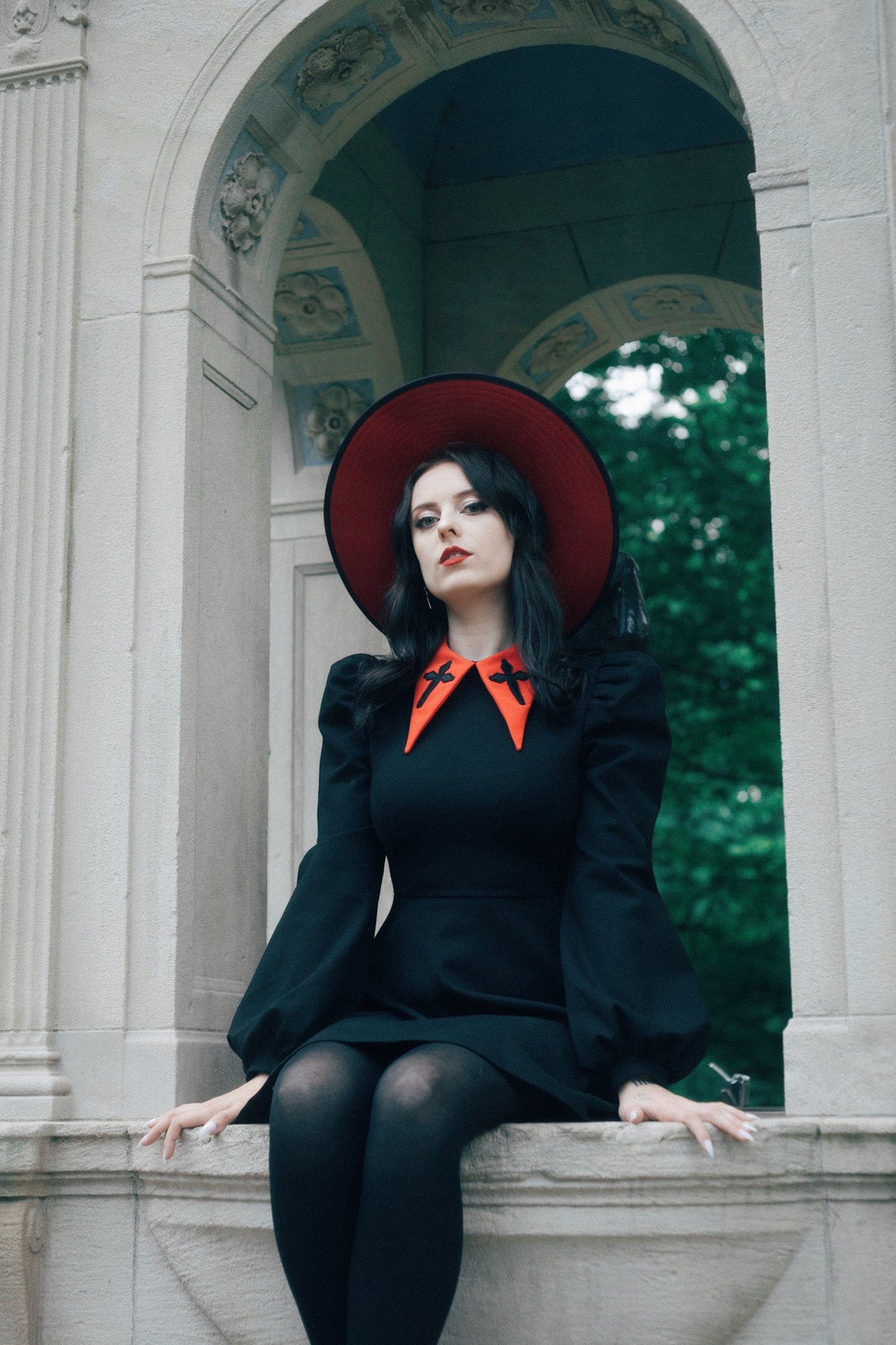 Shine in this sophisticated black Baptism Dress, designed with a bold pointed collar adorned with delicate cross embroidery. Choose the classic black collar for understated elegance or the vibrant red collar for a playful twist. The puffed shoulders and bishop sleeves create a dramatic, stylish silhouette, and the thick, stretchy ponte fabric ensures comfort, warmth, and long-lasting wear.