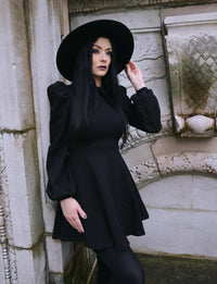 This black Baptism Dress combines elegance and whimsy, featuring a large pointed collar with subtle cross embroidery. Available in classic black or cheerful red, the collar adds a stylish focal point. Puffy shoulders and flowing bishop sleeves provide a charming, graceful look, while the thick, stretchy ponte fabric ensures your child feels cozy and comfortable, even during cooler months.