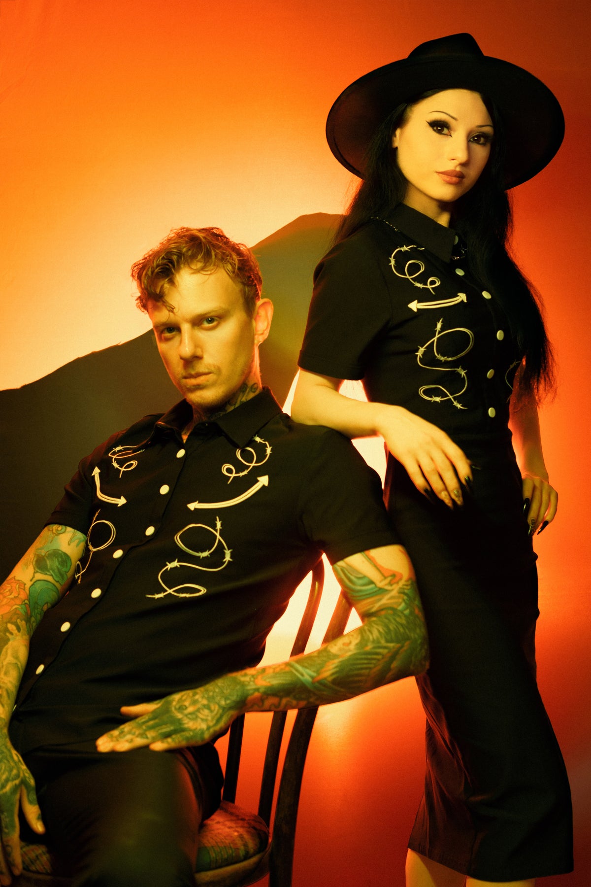 This black Bengaline men’s shirt combines edgy western inspiration with refined gothic style. Featuring intricate barbed wire and arrow embroidery across the chest, the fitted short-sleeve design contours the body while offering flexibility and comfort. The matte snap buttons add a subtle industrial touch, giving the piece a weathered, masculine appeal that makes it ideal for both casual and statement styling.