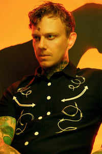 The Barb Wire Men’s Shirt embodies a dark western aesthetic with gothic sophistication, made from high-stretch Bengaline fabric for comfort, resilience, and a perfect fit. Across the chest, detailed barbed wire and arrow embroidery create a bold contrast against the deep black fabric. Finished with durable matte snap buttons, this short-sleeve shirt balances rugged craftsmanship with modern edge, ideal for alternative fashion lovers seeking a standout look.