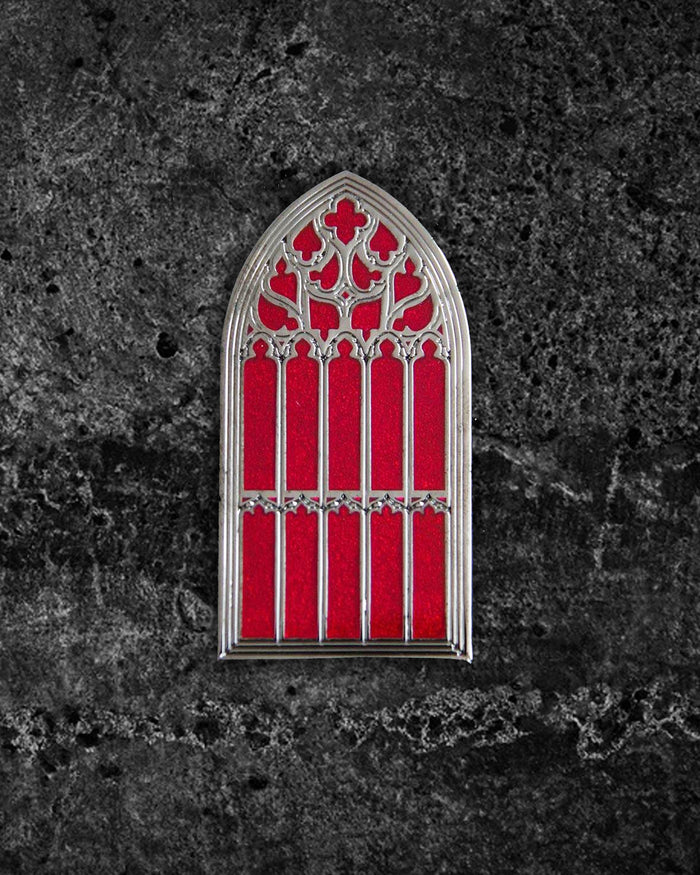 Silver and red hard enamel gothic brooch inspired by the great window of Saint Giles Cathedral in Edinburgh, Scotland. Measuring 2 x 1 inches, this collectible pin features two metal clasps for secure wear on jackets, hats, or bags. Ectogasm signature stamped on the back for authenticity, perfect for gothic accessory collections.