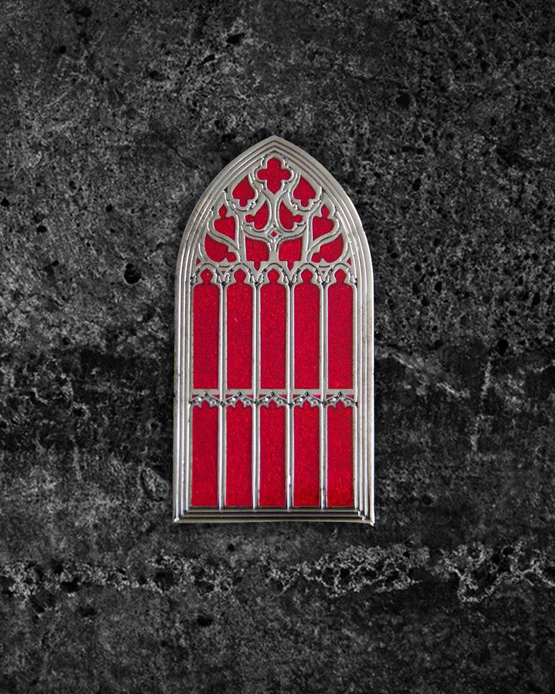 Silver and red hard enamel gothic brooch inspired by the great window of Saint Giles Cathedral in Edinburgh, Scotland. Measuring 2 x 1 inches, this collectible pin features two metal clasps for secure wear on jackets, hats, or bags. Ectogasm signature stamped on the back for authenticity, perfect for gothic accessory collections.