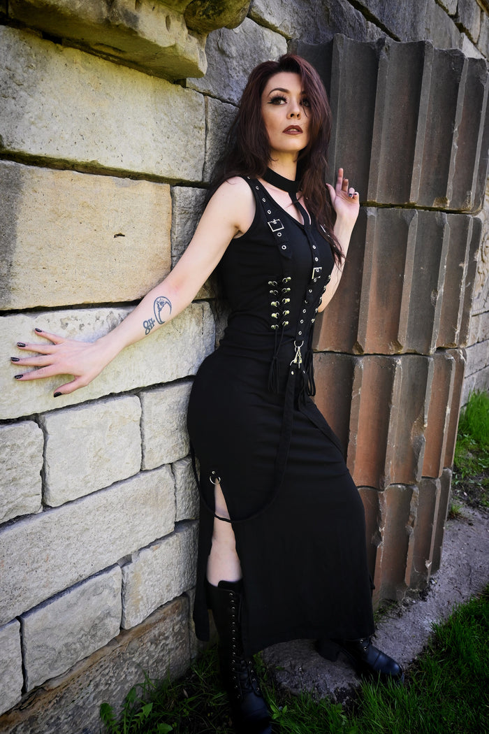 Dark alternative midi dress made from high-quality cotton-elastane fabric for comfort and flexibility, featuring a built-in stand collar, intricate corset lace panels at the bust and back, and detachable shoulder straps, perfect for gothic-inspired looks, alternative fashion styling, evening events, or layering with edgy accessories.