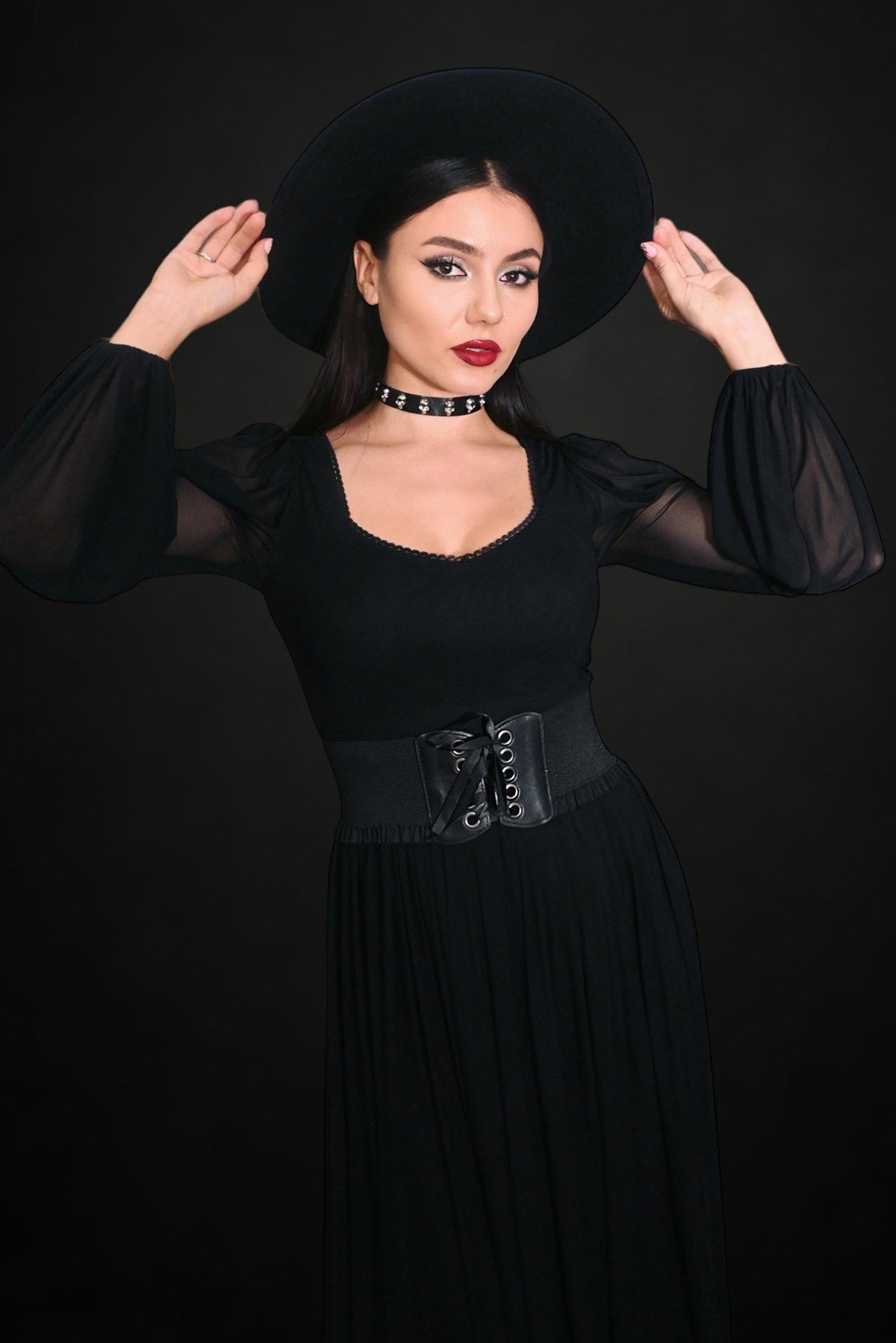 Adjustable lace-up corset-style belt with stretchy side panels, high-waisted and structured front in bold black or vibrant red, ideal for accentuating the waist and creating a striking, figure-flattering look when worn over casual or formal outfits.