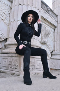 Tailored high-waisted black Dallas Pants crafted from stretch denim, offering a fitted silhouette with all-day comfort. Accented with subtle tonal black rose and thorn embroidery down the legs, functional belt loops, and a back zipper for a sleek, dark romantic finish.