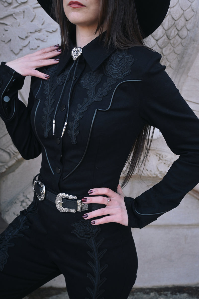 Made from durable, high-stretch denim, the Dallas Top maintains its shape and intricate black rose and thorn embroidery over time, offering both comfort and a statement gothic aesthetic that stands out in casual or alternative fashion ensembles.