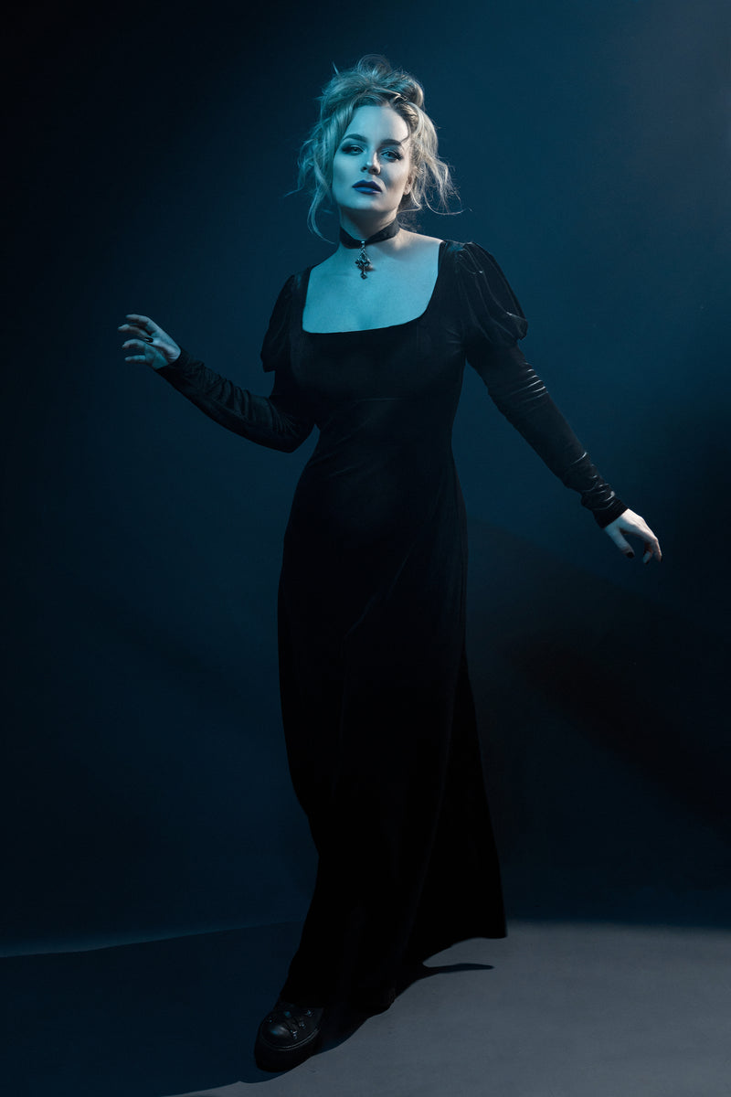 This black velvet Daphne Dress merges vintage Regency inspiration with modern gothic charm. Designed from soft, stretchy polyester velvet, it features a classic empire waist that enhances natural curves, long puffed sleeves for a dramatic silhouette, and a scoop neck that exudes feminine grace. A perfect blend of Victorian allure and dark romantic style for evening wear or elegant alternative fashion.