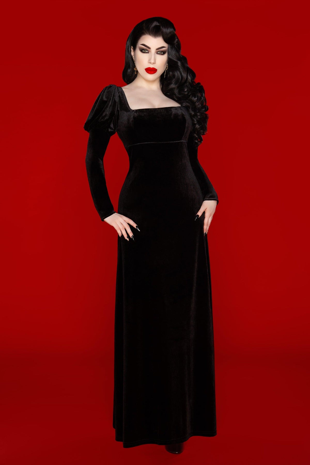 A statement of gothic elegance, the Daphne Dress is crafted from plush black velvet polyester that’s both soft and elastic. The empire waist flatters the figure, while the puffed Victorian-style sleeves and scoop neckline evoke a sense of romantic refinement. Inspired by Audrey Hepburn’s dress in War and Peace, this piece is perfect for those drawn to dark, historical-inspired fashion.