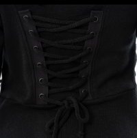 Full-length alternative-style black cardigan with fitted bodice, front and back corset lacing, oversized hood, zip closure, thumbholes, high-low hem, and 100% polyacrylic fabric, offering a dramatic silhouette for gothic or edgy fashion, easily styled for layered or standalone outfits.