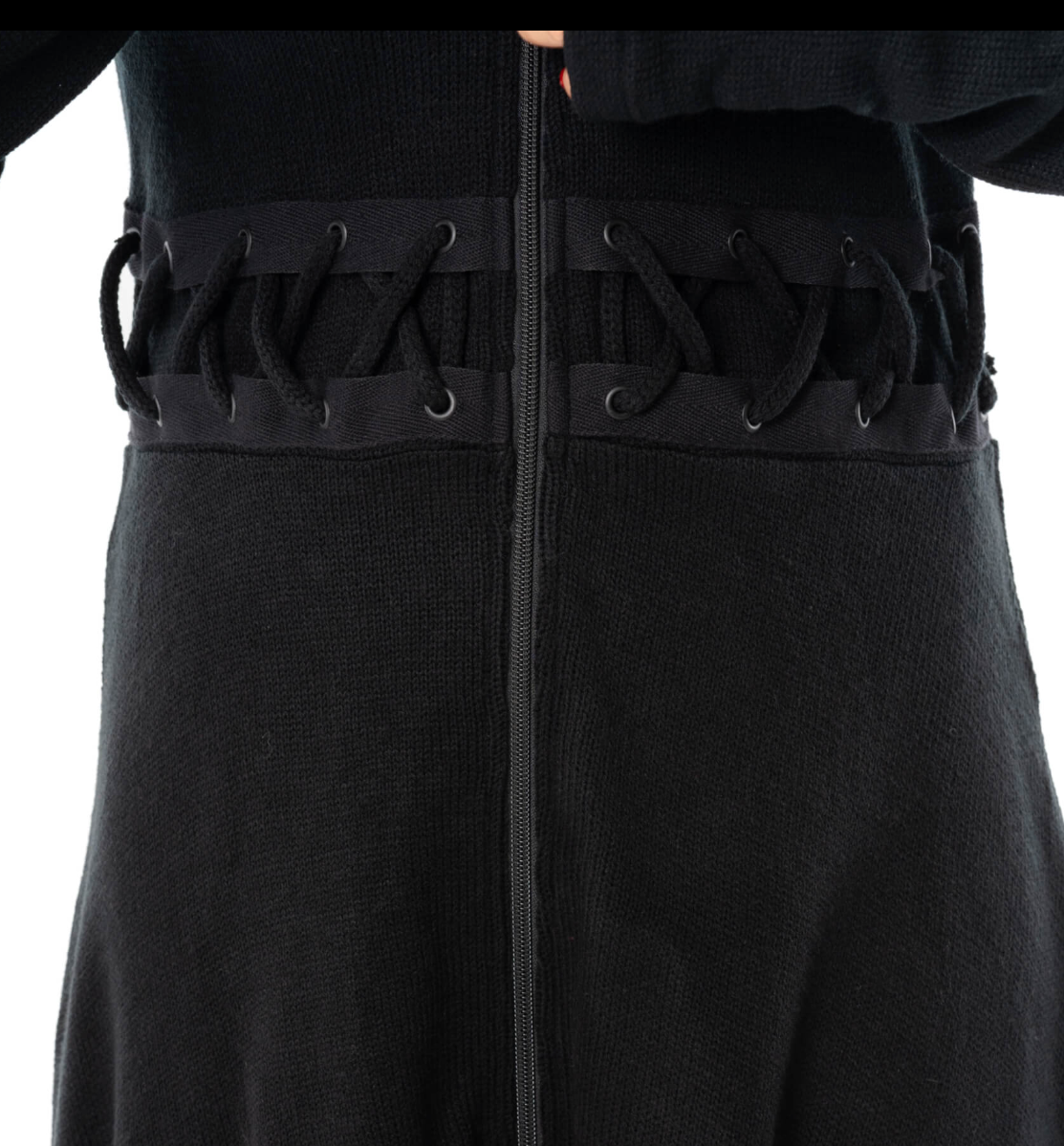A moody, full-length black Demille Cardigan made from soft polyacrylic with structured edges, front and back corset lacing, oversized hood, zip closure, high-low hem, and thumbholes, perfect for gothic fashion enthusiasts seeking versatile layering pieces or statement outerwear.