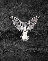 Silver and black enamel lapel pin featuring a nude woman with large outstretched bat wings and a crown of roses in her black, star-filled hair. Measuring approximately 2 x 1.5 inches, this eerie yet elegant gothic pin by Ectogasm includes two metal clasps for secure wear on jackets, hats, or bags.