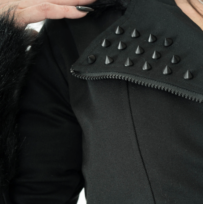 Black Effia Jacket by Heartless combining edgy design and practicality with durable cotton blend outer, polyester faux fur lining, spike studs, asymmetrical zipper, panel seaming, plush hood and cuffs, and adjustable side straps for a fitted and stylish cold-weather jacket.