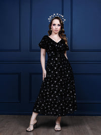 Elegant black velvet Heavenly Body Dress adorned with sparkling starburst designs, vintage butterfly sleeves, side slits, and a cinched waist. This chic Valentino-inspired dress blends timeless 1940s glamour with contemporary art deco style, ideal for parties, formal events, and making a striking fashion statement.