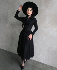 Designed for versatility, the Homemaker Swing Dress in black features a flattering midi-length cut and long sleeves, making it suitable for various occasions. The hidden front button placket and functional side pockets combine style with functionality. The high-stretch Bengaline fabric ensures a comfortable fit, while the flared skirt adds a touch of elegance to the overall design.