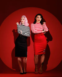 A bold and edgy Jailhouse Dress featuring a black-and-white striped mock turtleneck top with long sleeves and a super-stretchy bengaline pencil skirt, designed for a curve-hugging fit and maximum comfort, complete with unique skull embroidery artwork by Jessica Louise for a rebellious gothic-inspired look.