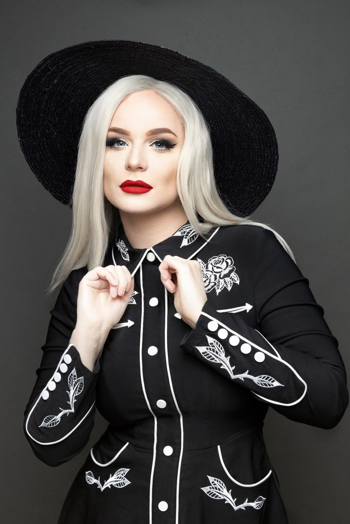 Sophisticated yet playful women’s skater dress with detailed rose and thorn embroidery on the collar, cuffs, bust, and hips, accented with white piping, long piped sleeves with faux snap cuffs, a flattering flared skater skirt, and convenient deep pockets, making it a stylish choice for casual, work, or evening wear.