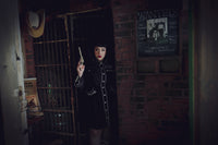 Women’s black and white skater dress featuring a playful flared skirt with deep pockets, long piped sleeves with faux snap cuffs, detailed rose and thorn embroidery on the collar, bust, hips, and cuffs, and white piping accents, combining timeless feminine style with functional design for day-to-night wear.