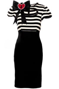 A feminine and edgy Molly Keyhole Dress featuring Jessica Louise’s signature design elements, including a keyhole bust cutout, puffed sleeves, and delicate ruffle accents. Made from premium stretchy bengaline fabric, this high-waisted dress molds effortlessly to the body, creating a sleek and flattering hourglass shape. The addition of the Heart Bow detail adds a sweet, distinctive finish that makes the dress stand out as a statement piece for gothic, pinup, or retro-inspired wardrobes.